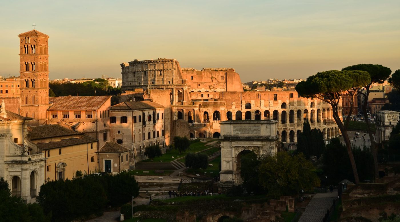 The Roman Forum at sunset with the Colosseum behind